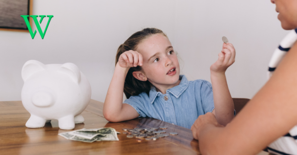 Young girl with a piggy bank and coins