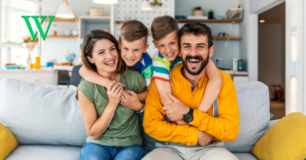 Parents and children sitting together on couch