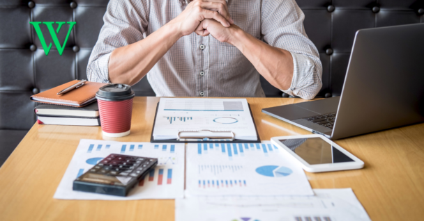 Man at table reviewing his investment plan